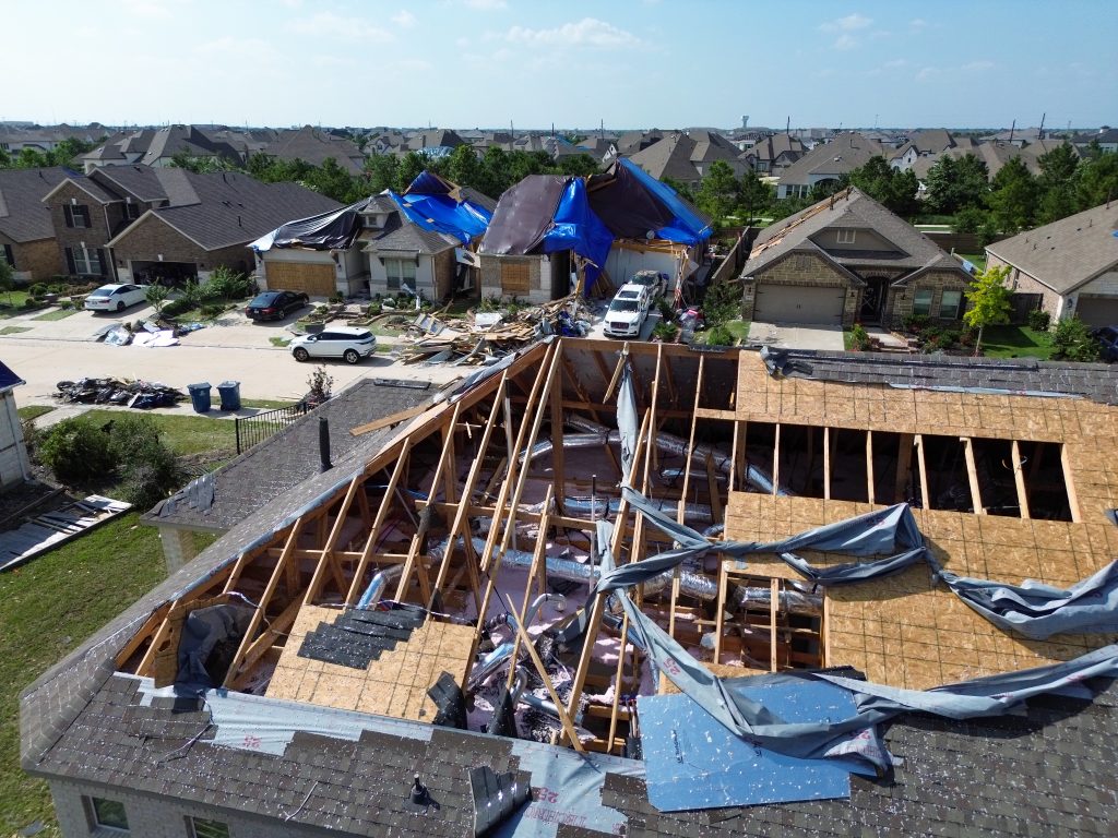 Homes with severe damage to their roofs after a tornado moved through