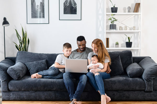 happy family of 3 on blue sofa